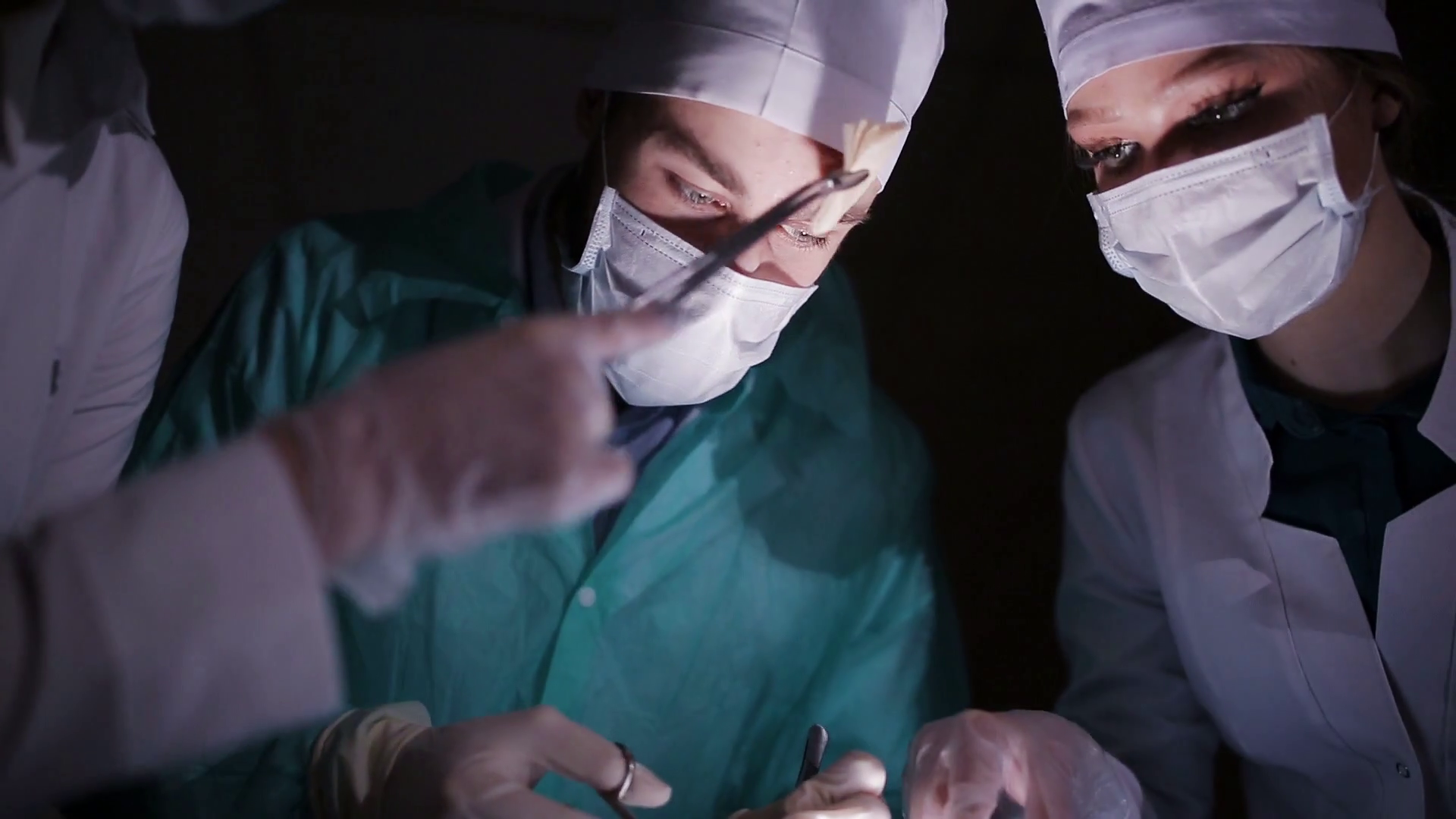 Doctors surgeons operate patient in operating theater. Surgical team performing operation in