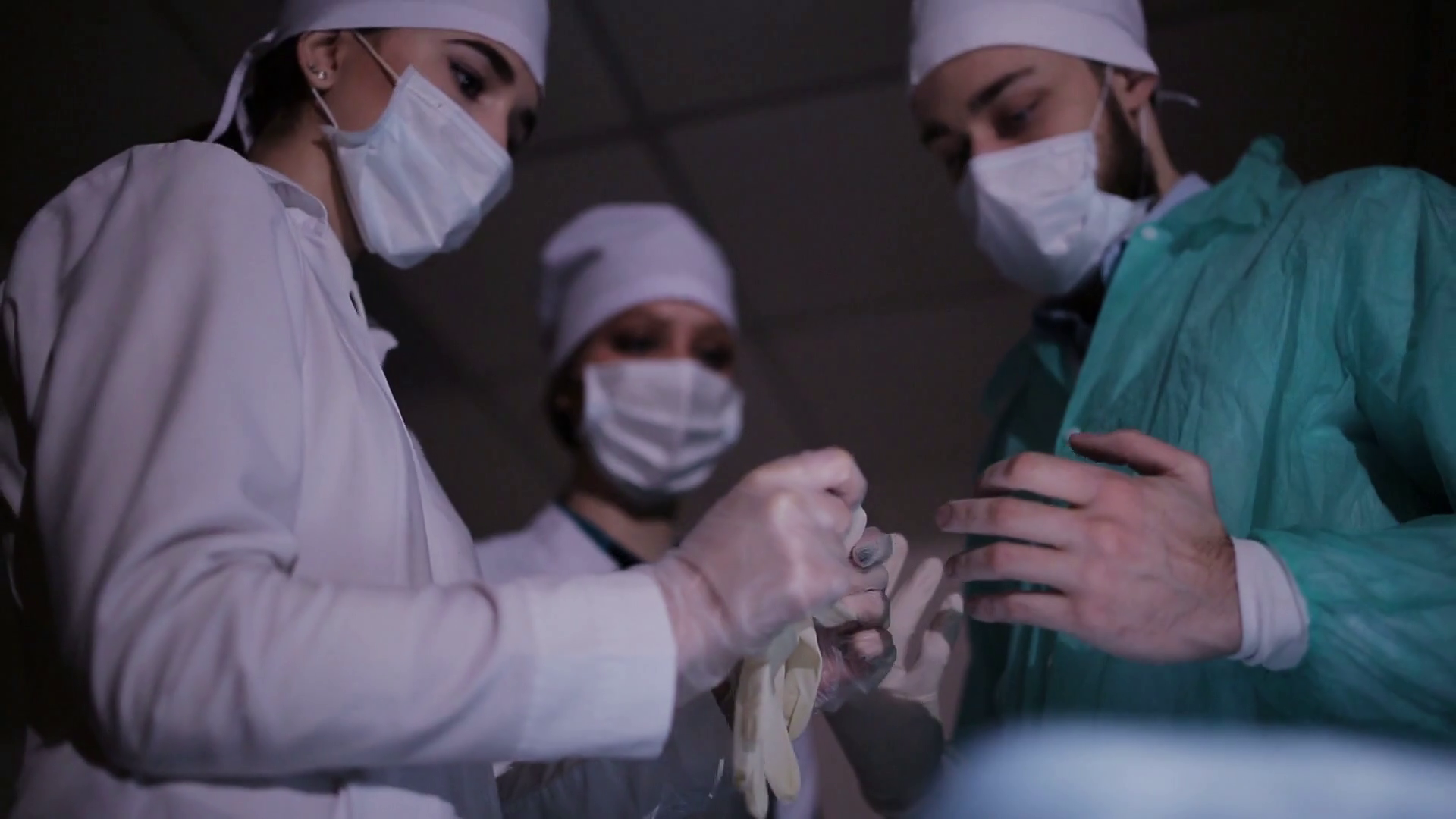 Nurse helps the surgeon to wear gloves for surgery Stock Video Footage