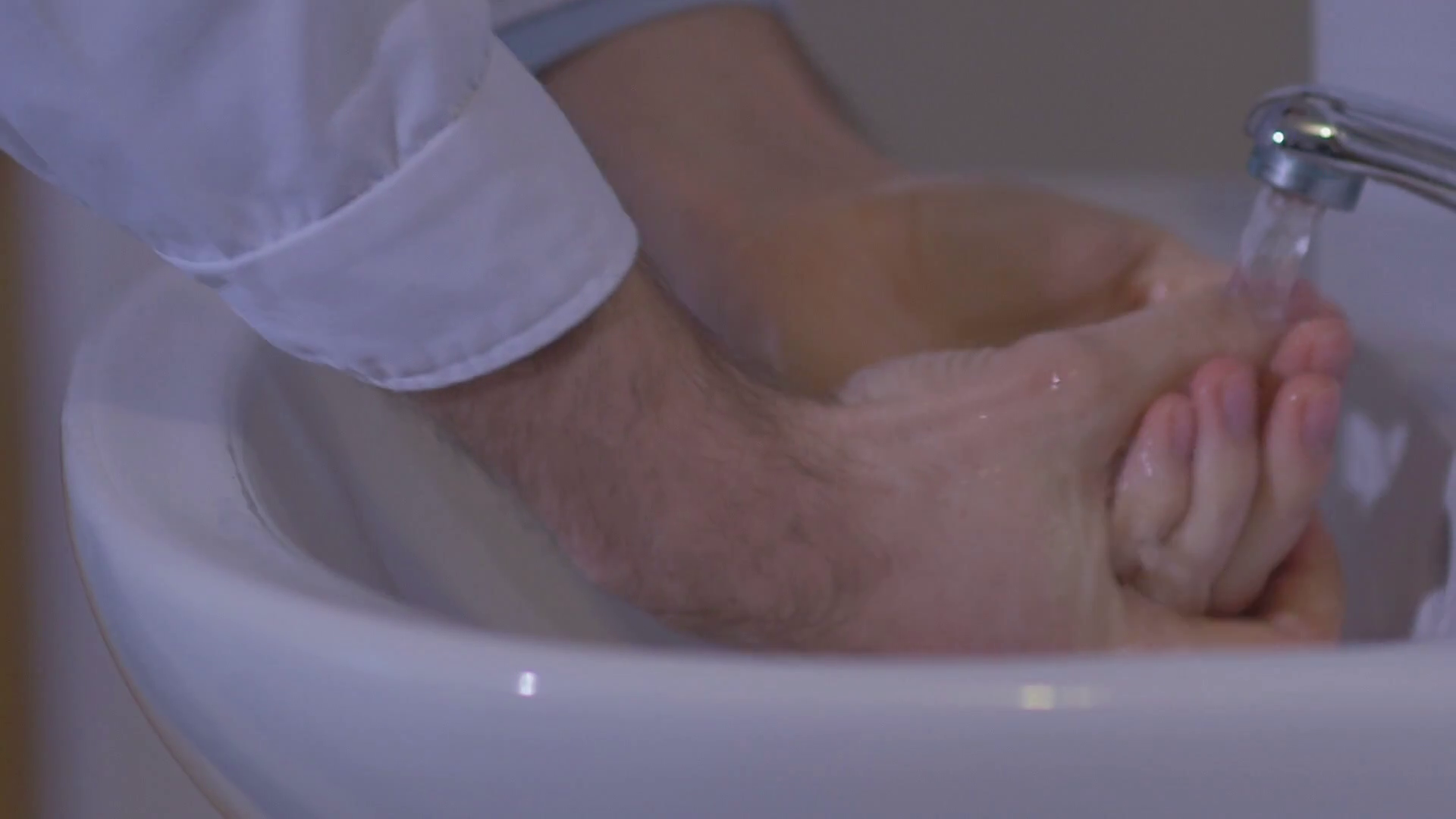 Slow motion doctor carefully wash their hands before surgery Stock