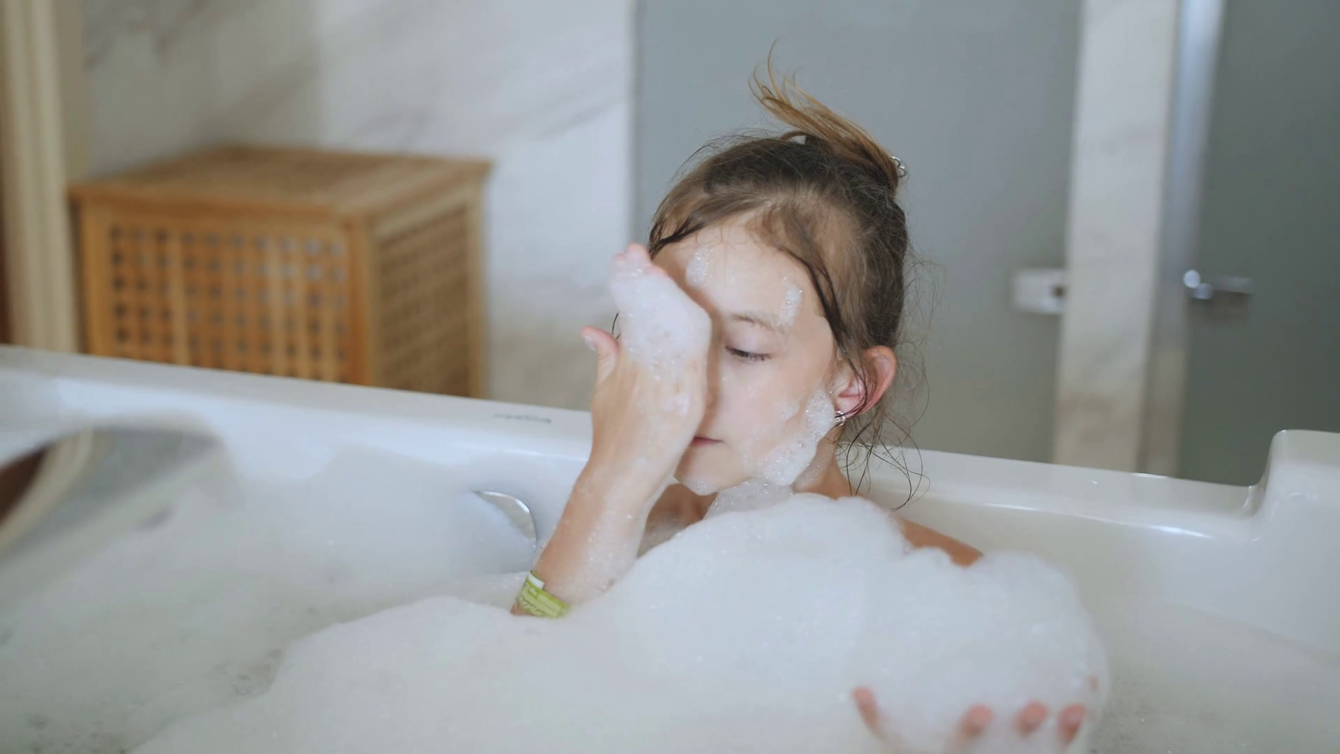 Little girl takes a bath full of foam. Stock Video Footage 0027 SBV