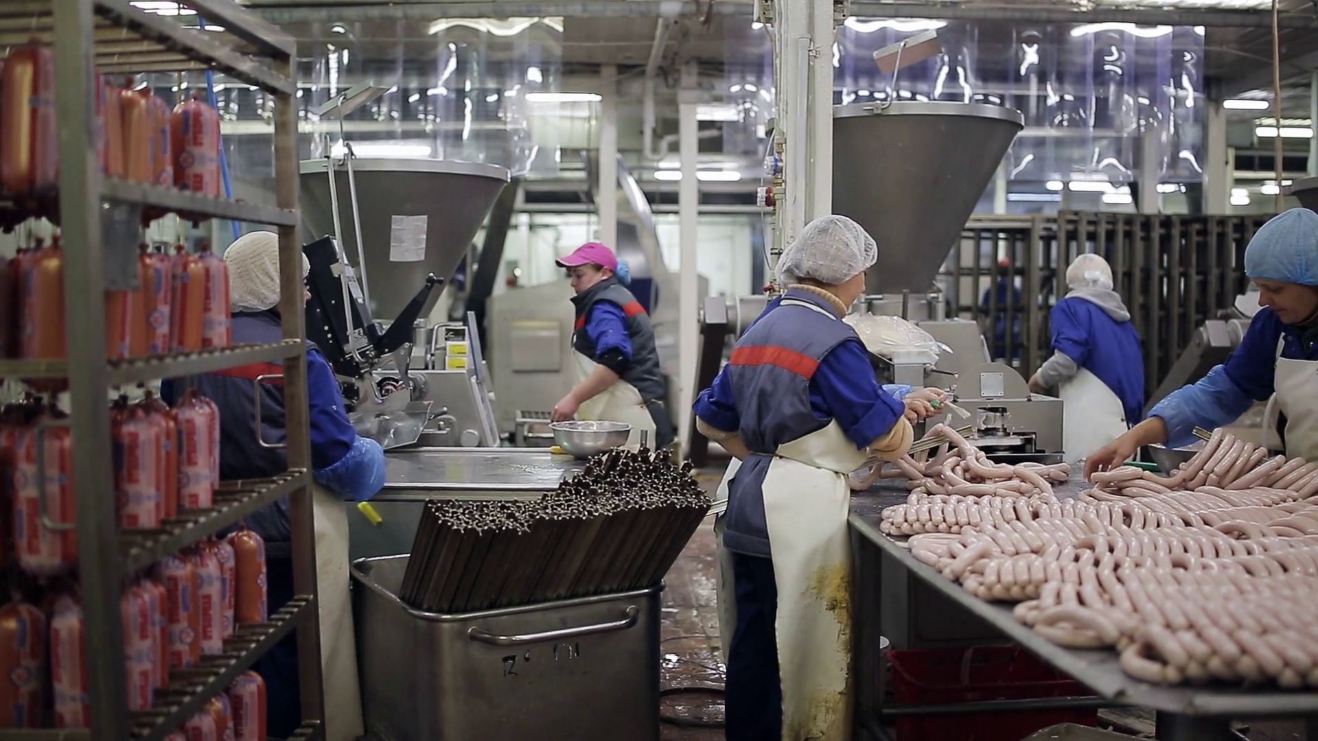 a large for the production of sausages. Workers in uniform