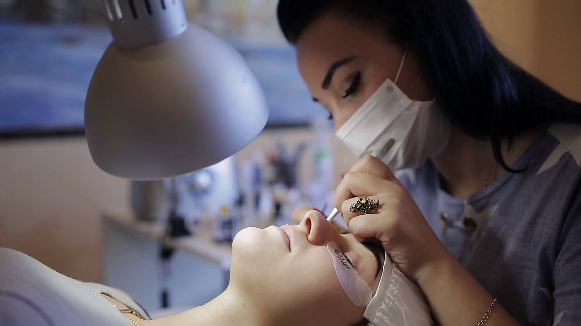 Master cosmetologist works with a nebulizer after the procedure