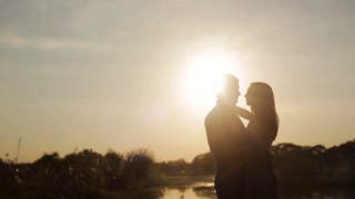 Romantic date at sunset. Lovers walk holding hands. Love story. Honeymoon. Love at first sight