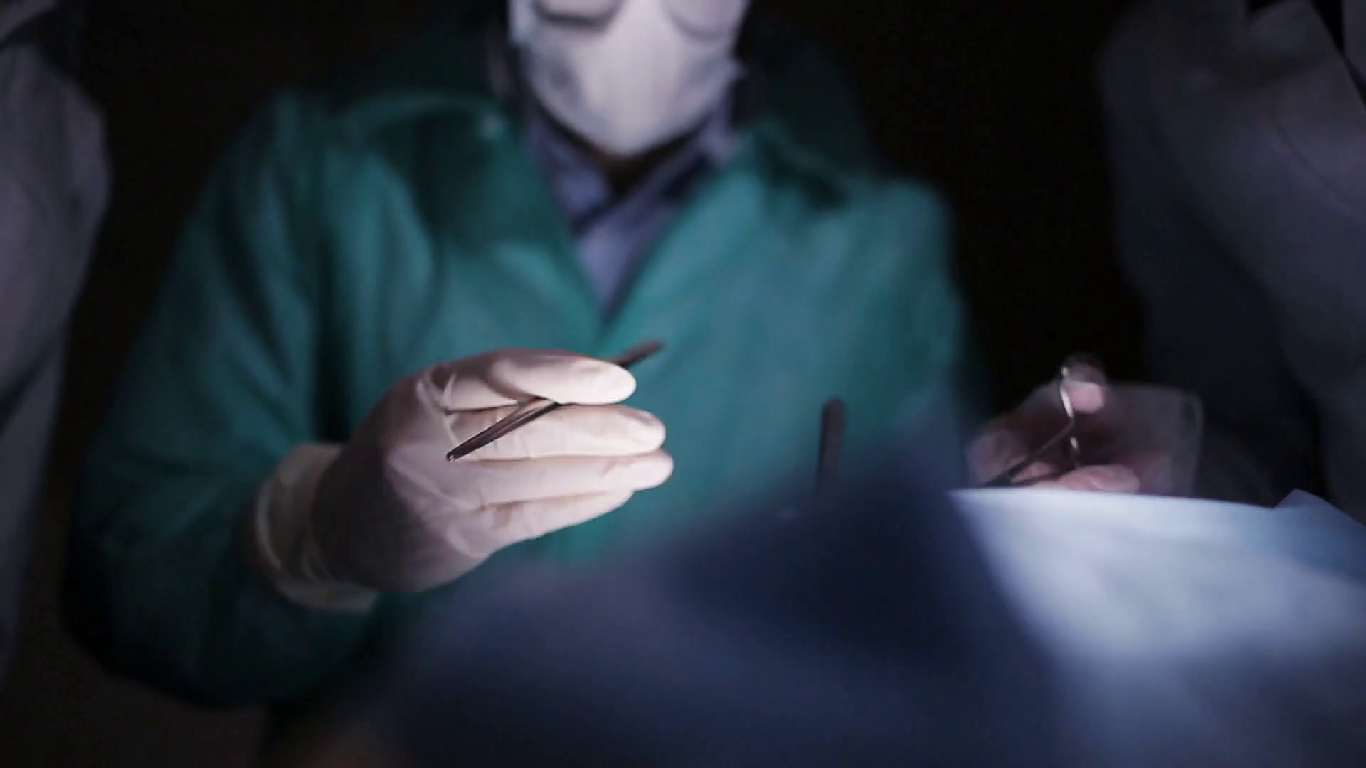 Surgeons team preforming operation in hospital operating theater, close