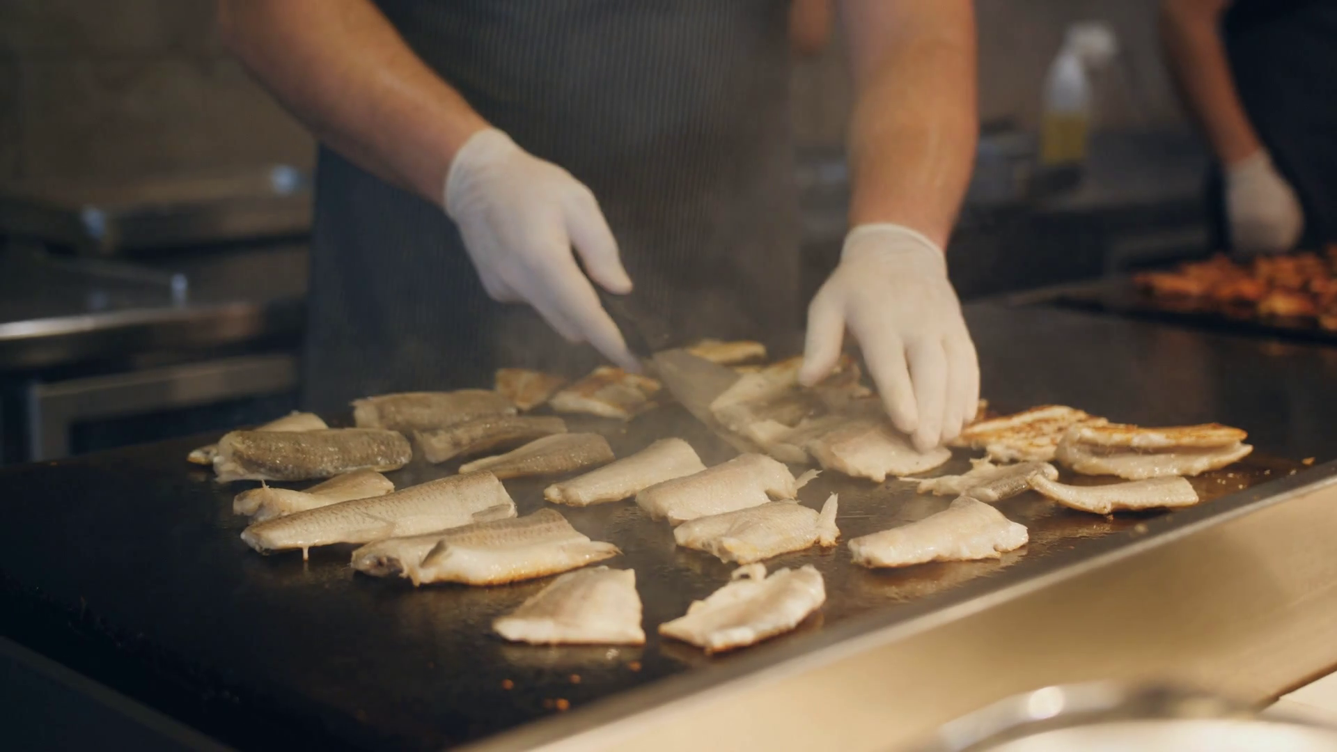 The cook fry fish on the stove in a fish restaurant. Stock Video