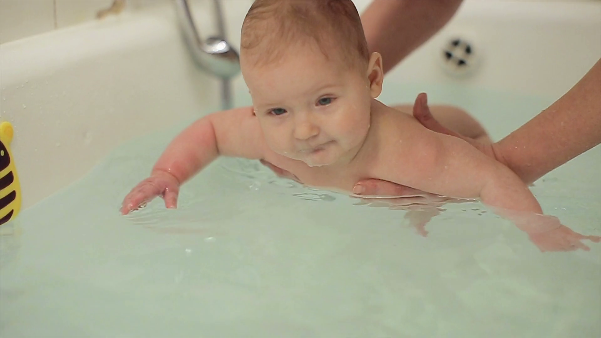 Mother bathes the baby in the bath.child swims in the bath Stock Video Footage 0017 SBV