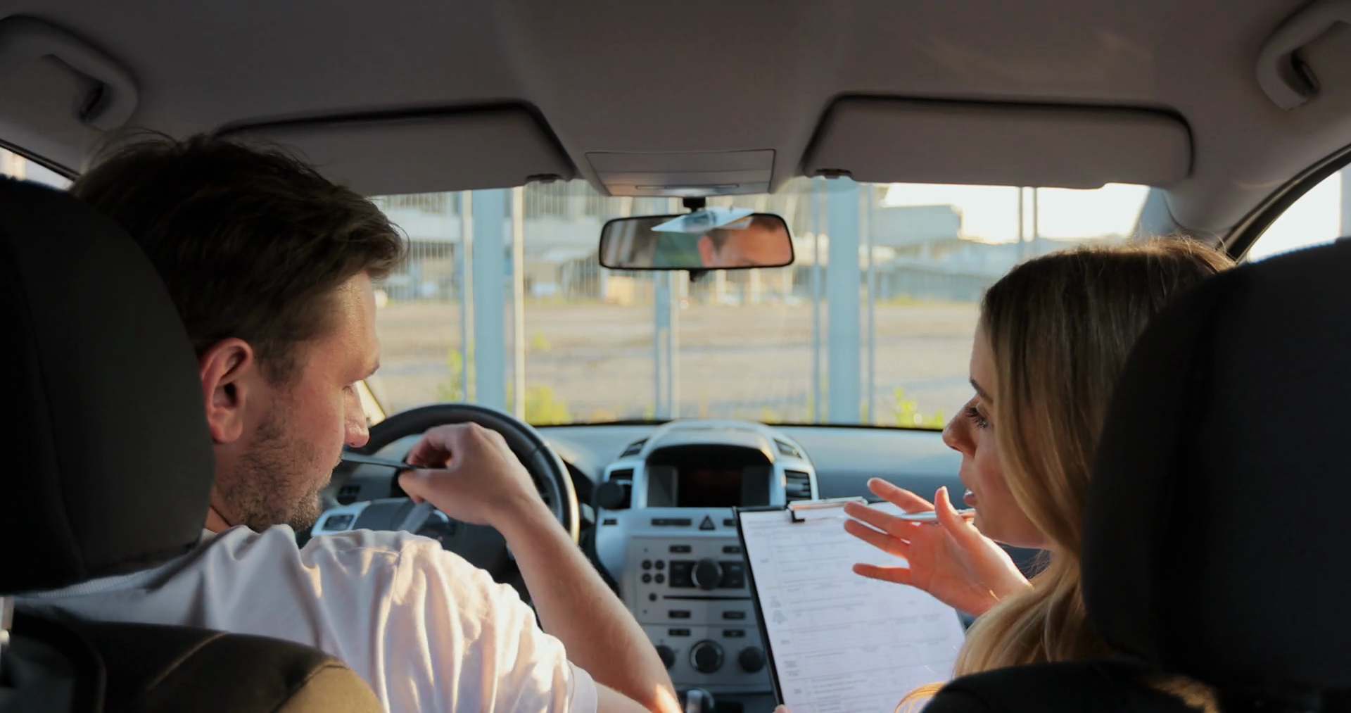 Car Instructor Teaches Young Man To Drive Stock Footage SBV348425506