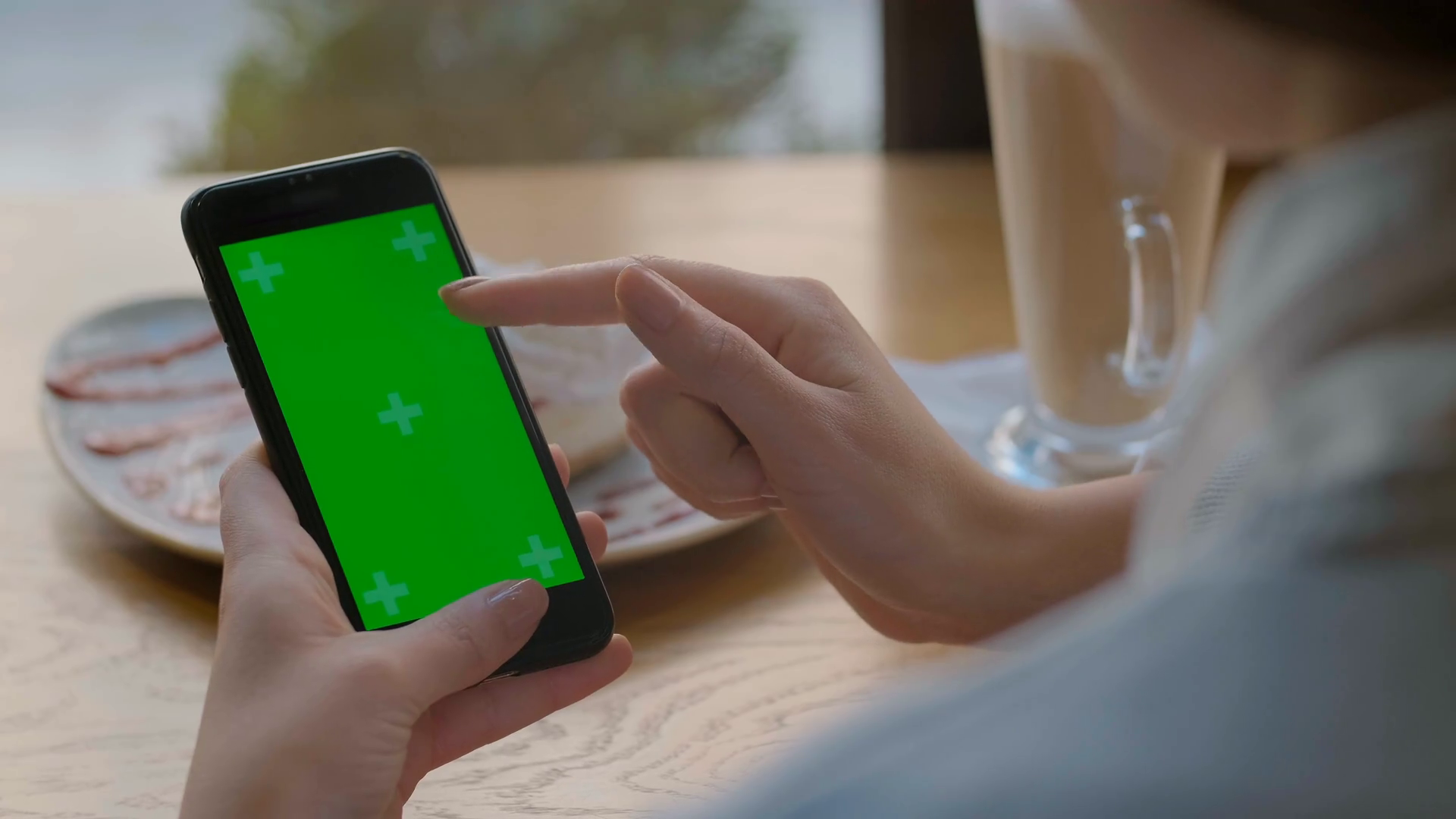 Businesswoman using mobile cell phone with green touch