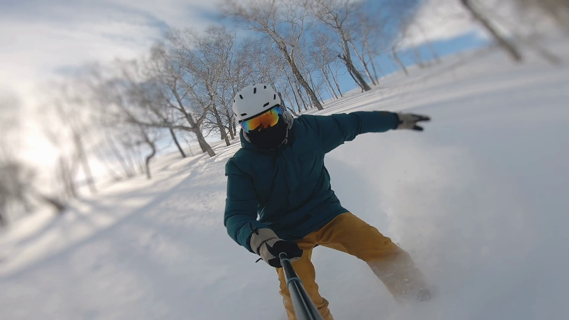 Guy doing snow splash rising on magnificent sunny day. Concept of