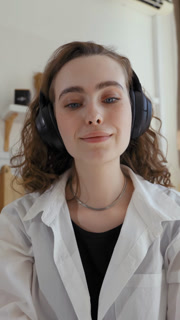 Vertical Of Woman In Headphones Enjoys Listening Favorite Song At Home | High Quality Visual