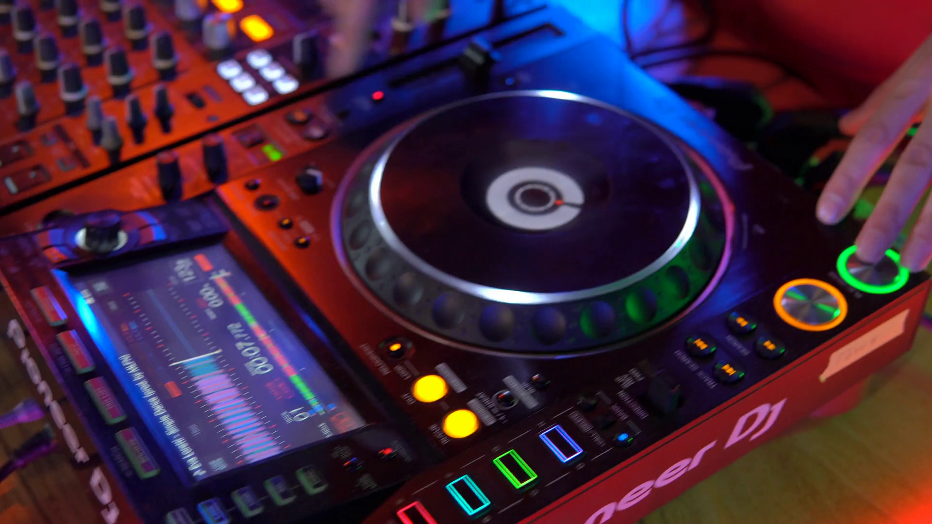 Hand of Dj on the mixing console twist turntable. Slide down shot