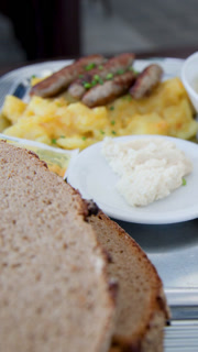 Close-Up Pan of Traditional German Sausage Meal on Plate