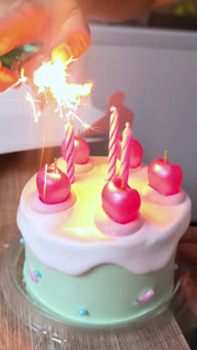 Lighting Pink Birthday Candles on Iced Cake in Bangkok