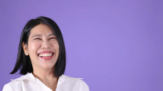Smiling Woman Waving Hand in Studio With Purple Background