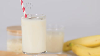 Chia Seeds Falling Into Fresh Banana Milk Smoothie Glass