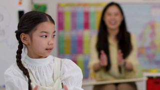 Young Girl Learning to Tell Time in Classroom Activity