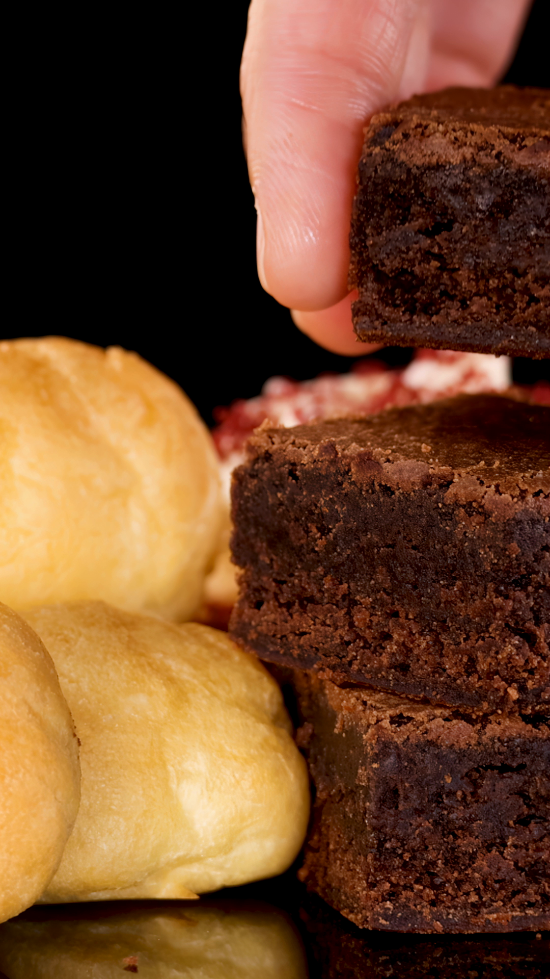 Hand Stacking Brownies Beside Cream Puffs Stock Footage SBV-353065495 ...
