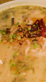 Spicy Sichuan Fish Soup with Chili Peppers in White Bowl