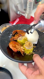 Chef Pouring Soy Sauce Over Fresh Dim Sum and Fried Shrimp
