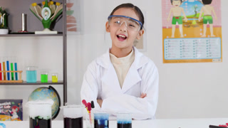 Young Asian Girl Scientist in Lab Coat Giving OK Hand Gesture