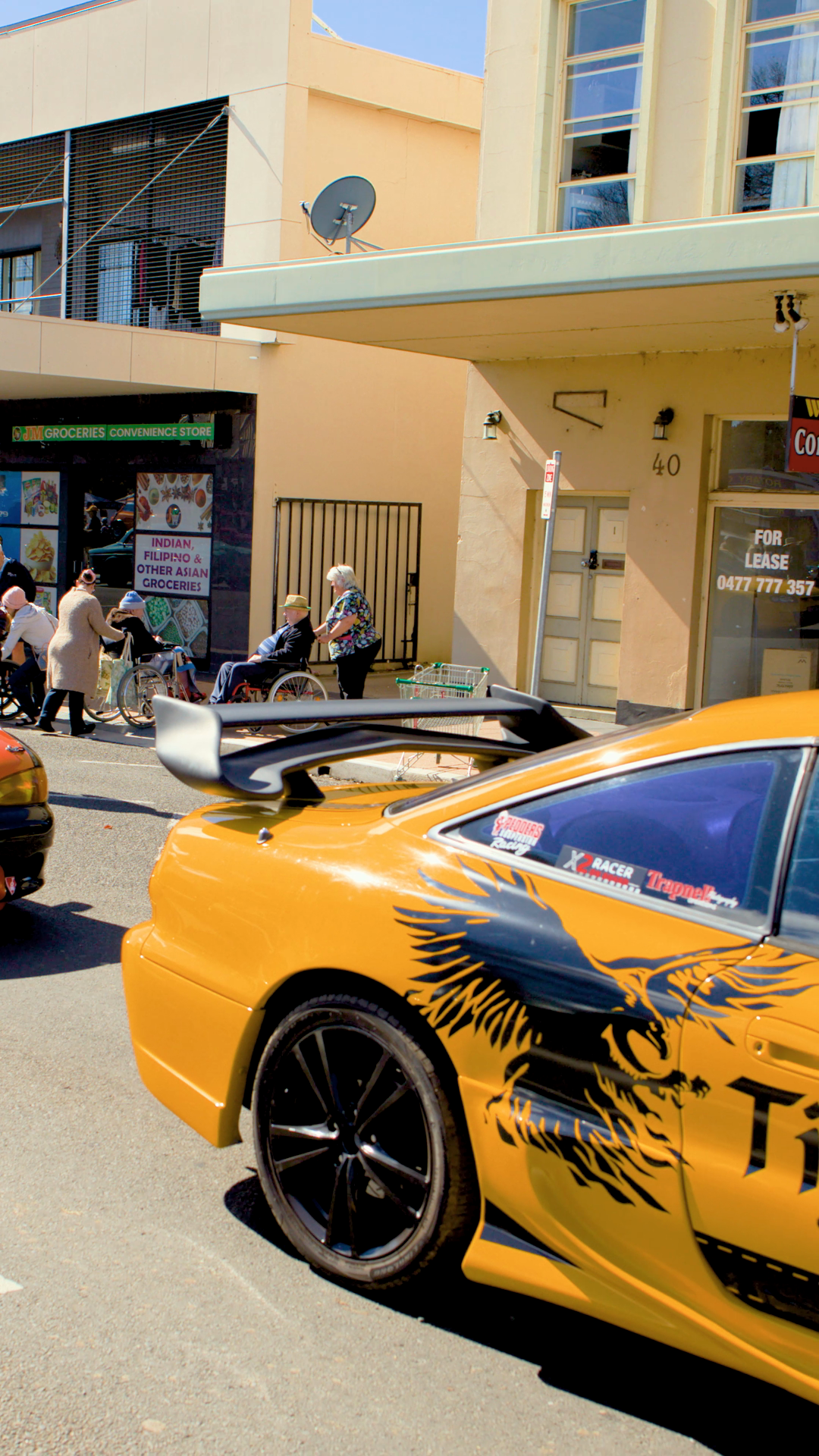 Yellow Sports Car Passes Downtown Shops Stock Footage SBV-353094749 ...