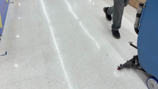Industrial Floor Scrubber Machine Cleaning a Shiny Airport Terminal Floor