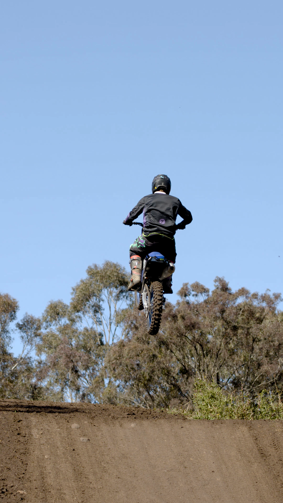 Motocross Rider Jumps Dirt Ramp On Sunny Day Stock Footage SBV ...