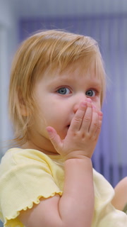 Close-up of mother teaching toddler to blow a goodbye kiss with a warm smile, heartwarming interaction between mother and daughter as they