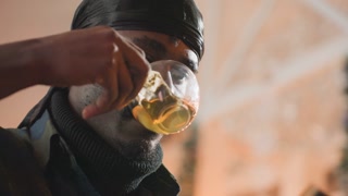 man enjoying tea thoughtfully captured, portrait of man savoring golden infusion in serene lighting, intimate depiction of man reflecting