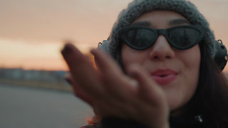 Happy woman smiling. Intimate shot of woman sending flirty kiss. Woman with bright smile and playful gesture close to camera. Closeup image