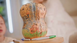 Kids creating festive pumpkin painting project. Family enjoying seasonal art activity with pumpkin decorations. Young child decorating