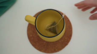 Relaxing start with warm drink. Enjoying peaceful morning with tea. Savoring calm routine in new surroundings with tea. Beginning day