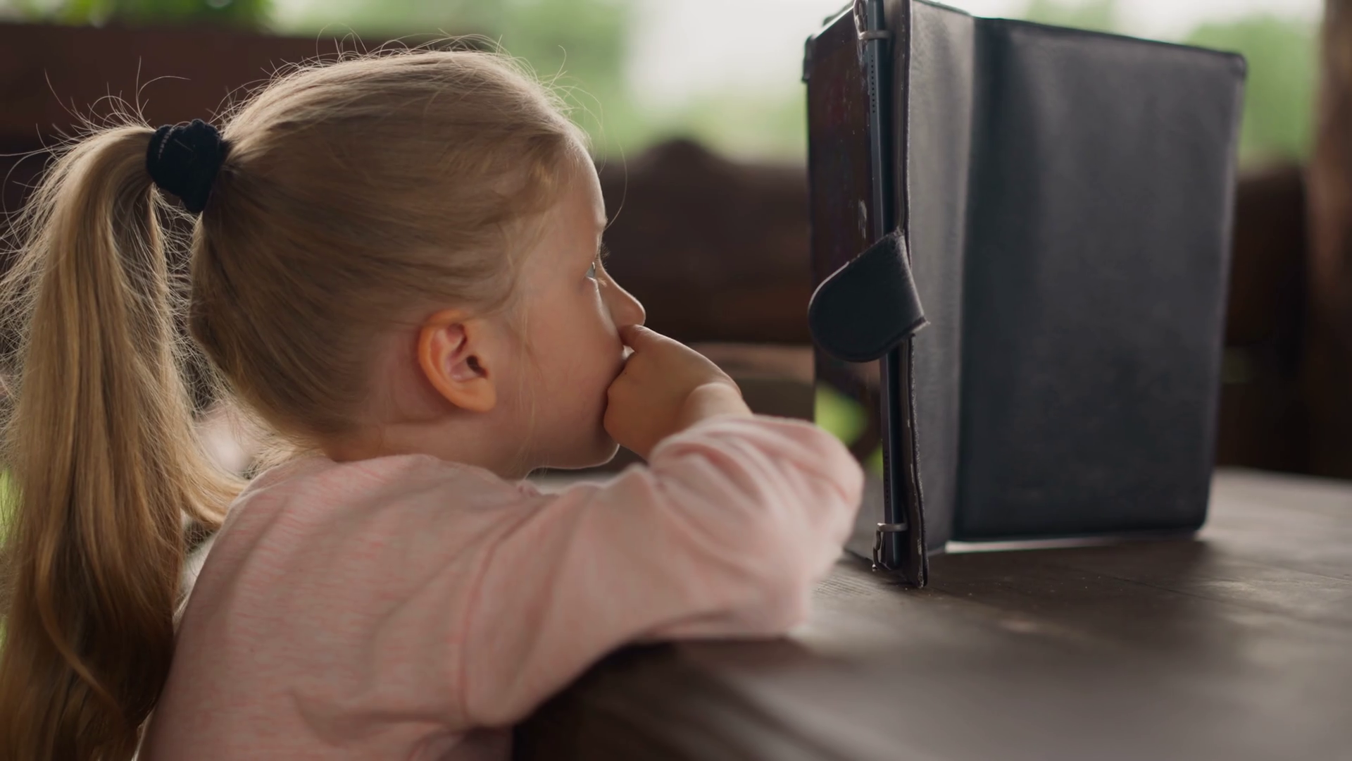 Little Girl Watches Cartoons Online Via Stock Footage SBV347439770
