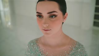 Portrait of Beautiful Woman with Elegant Makeup and Bun Hairstyle