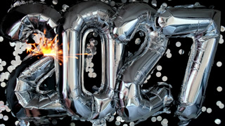 Happy new year 2027 metallic balloons with confetti and sparkler firework Bengal lights on dark black background. Greeting card silver foil