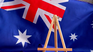 Australian flag and message board text HAPPY LABOR DAY festive holiday greetings. Concept of workers rights and public holiday, use in labor