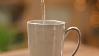 Pouring hot water into cup