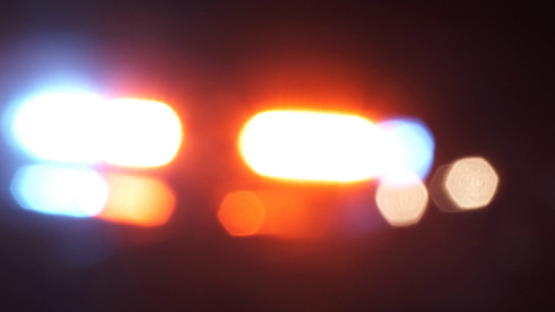 Soft Focus Police Lights Flashing With Night Traffic Stock Video
