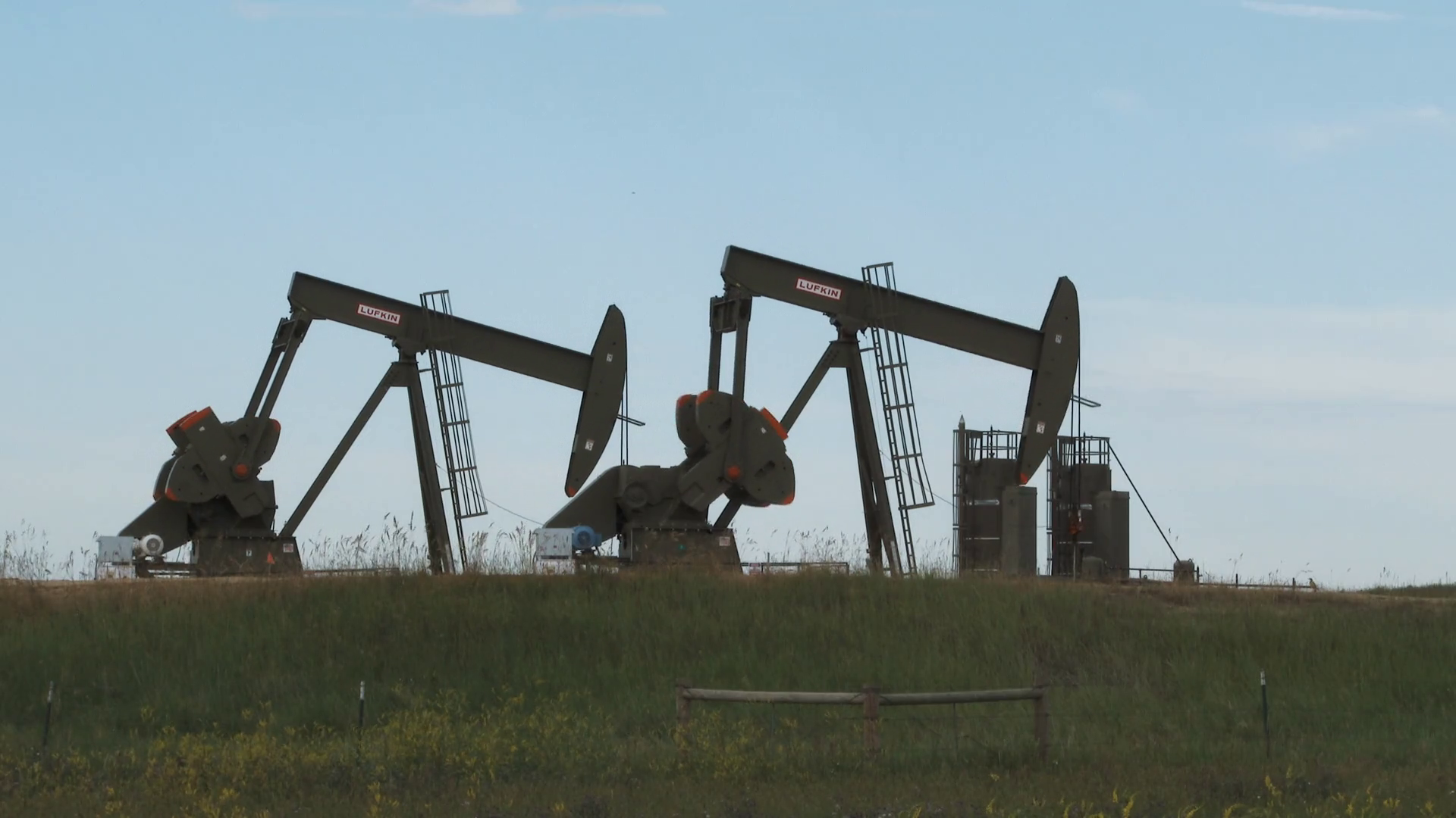 Two Oil Rigs Pumping Well In Field Stock Footage SBV336757660