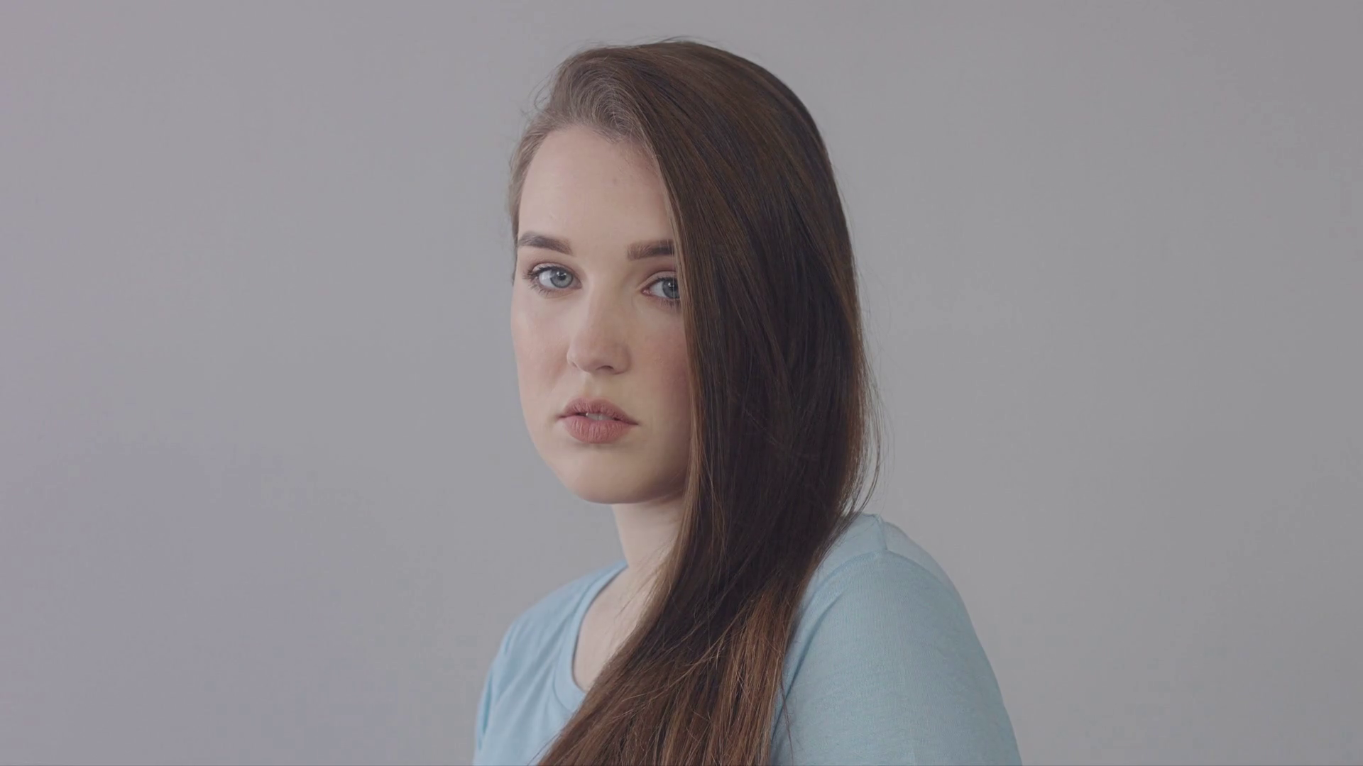 young baby face model in studio. Long straight hair blue eyed model in ...