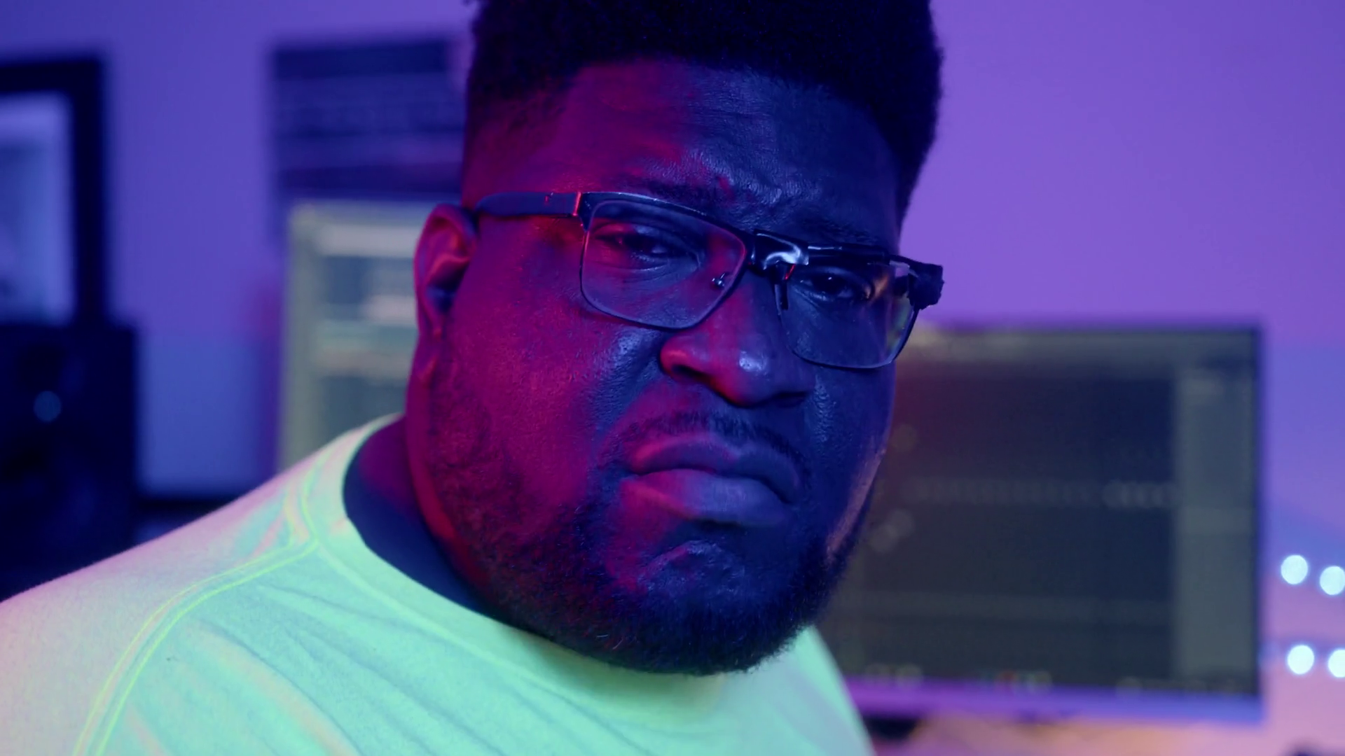 Portrait shot of music producer stank face in home studio. (60 fps