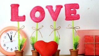 Valentine's day love decoration with clock heart gift and pink letter plants