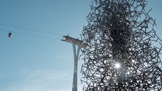 Emirates Air Line Cable Car and Quantum Cloud Sculpture By Antony Gormley in Greenwich London, UK.