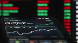 Close-up smartphone screen displaying financial trading app with portfolio growth, details charts and market data. Concept of investing, fintech, stock market performance and mobile wealth management