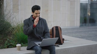 Multiethnic Businessman Sitting Using Laptop, Online Conference Distance Office Chat, Virtual Training, Speaking to the Camera, Using Earphones. Communication and Technology Concept