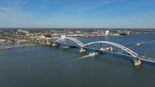 Timelapse of dense traffic on a bridge and river shipping in Europe