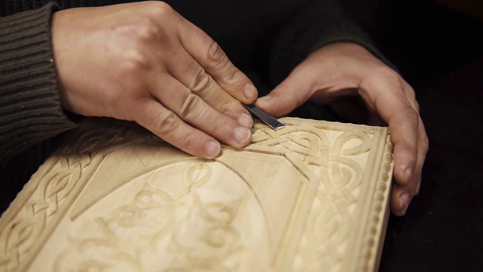 Handcarved wood closeup. Unrecognizable craftsman carving wooden