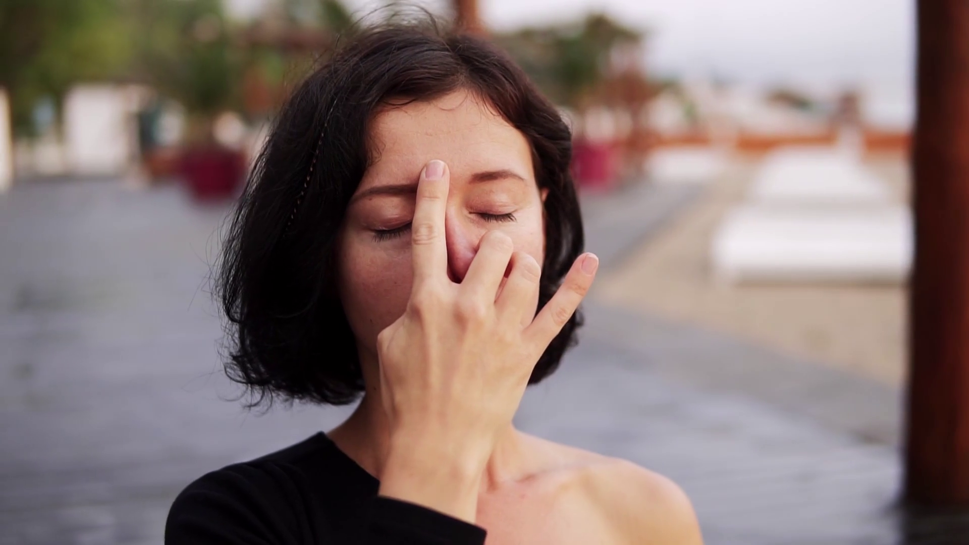 Woman practicing yoga exercise sitting in Sukhasana pose, performing
