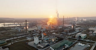 Plant for production of nitrogen peat Agropolychim Varna, Bulgaria. Large industrial plant with high pipes bright light of sunset aerial view. Thick smoke comes from high pipe. Environmental pollution