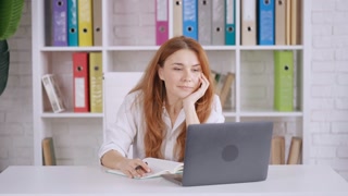 manager studying online webinar at home office using webcam on laptop sitting at the desk in office